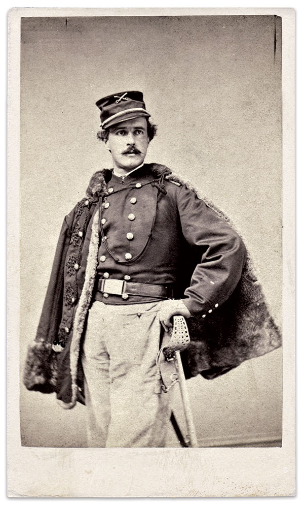 Col. George Waring, Jr., of the Frémont Hussars, a Missouri unit also known as the 1st Regiment Western Cavalry, wears a heavy fur-lined pelisse, with elaborate braid at button fastenings, over a double-breasted plain jacket. A small militia pattern 1851 dragoon/cavalry crossed saber insignia is attached to his 1858 Pattern cap. He holds a rare high-grade presentation sword retailed by Tiffany & Co. of New York City, and imported from England. Carte de visite by an unidentified photographer. Jérôme Lantz Collection.