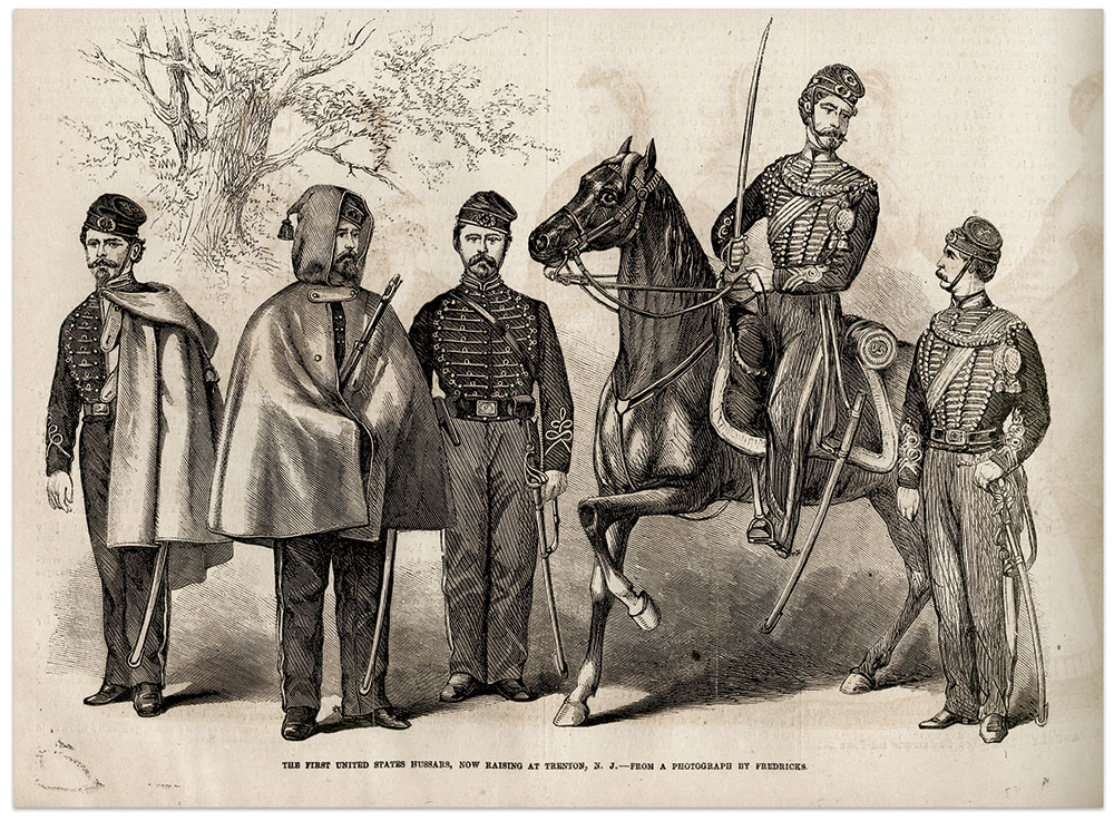 This engraving published in Frank Leslie’s Illustrated Newspaper on Jan. 9, 1864, illustrates forms of dress worn by the 3rd New Jersey Cavalry. Two men wear the talma or hooded cloak, with that at far left thrown back over one shoulder in imitation of a pelisse. The two officers on the right wear more elaborately trimmed jackets with baldric and aiguillette, or cord with lace tags, across their shoulders. The caption notes that the engraving is based on a photograph produced by New York City photographer Charles D. Fredericks. Anne S.K. Brown Military Collection. Brown Digital Repository. Brown University Library.