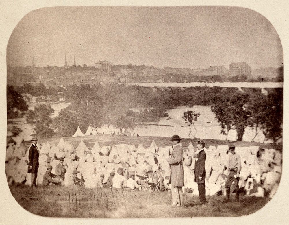 Rees at Belle Isle: Located in the middle of the James River outside Richmond, Belle Isle became the unwanted home for over 30,000 Union prisoners during the war. Rees likely took this photo in August 1863 during his service with the 19th Militia, a regiment primarily composed of shopkeepers, railroad workers and foreigners in the city of Richmond not eligible for regular army service. Mobilized July 2, 1863, to guard prisoners captured at the battles of Second Winchester and Gettysburg sent to Libby Prison, Castle Thunder and Belle Isle, they proved more of a nuisance than help. An irate Brig. Gen. William M. Gardner wrote of the hapless militiamen, “The Virginia Militia proves to be unfit for the duty of guarding prisoners. They exhibit a want of discipline and insubordination that demonstrates they cannot be depended on for the security of the prisoners.” The officer standing in the foreground, Capt. Thomas P. Turner, served as the commandant of Libby Prison. During the evacuation of Richmond in April 1865, Turner escaped with the rest of the army and eventually fled to Cuba to avoid retribution by Union authorities—and possibly the same fate as fellow prison warden Henry Wirz. Detail of stereocard by an unidentified photographer from an original Rees image lost in the Richmond fire on April 3, 1865. Library of Congress.