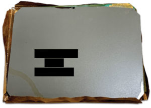 Back of the tintype hidden beneath the false back (name of photographer redacted).