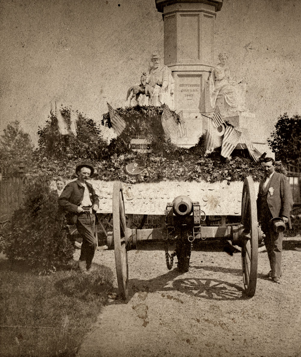 A wagonload of fresh flowers for the May 30, 1874, Decoration Day services at the National Memorial is flanked on the right by early tour guide William Holzworth, soon to be appointed the Cemetery’s second superintendent, and, on the left, possibly Nicholas G. Wilson, the first elected Superintendent of the Cemetery. Stereo card by Peter S. Weaver of Gettysburg, Pa.