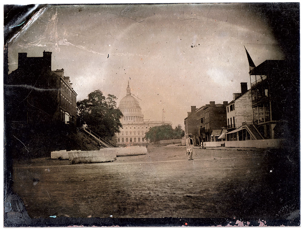 These views of the new dome reveal construction towards the end of its completion, as evidenced by exposed beams between the rounded top of the cupola and the base of the tholos upon which rests the Statue of Freedom. They were taken a few blocks away at North Capitol and C Streets. In the middle ground of the bottom image, a wagon delivers Godey’s Boston Ice to the Union Saloon. Opposite is the Sanitary Commission, with its triple porch and two chimneys. Tintypes (about half-plate size) by William Kunstman. Kyle L. Miller Collection.