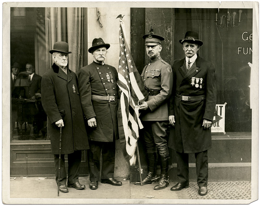 The Grand Army of the Republic veterans pictured with this U.S. Army major likely belonged to the same post. The men standing on each side of the major wear the Brooklyn Medal. Print by an identified photographer. Brian Bennett Collection.